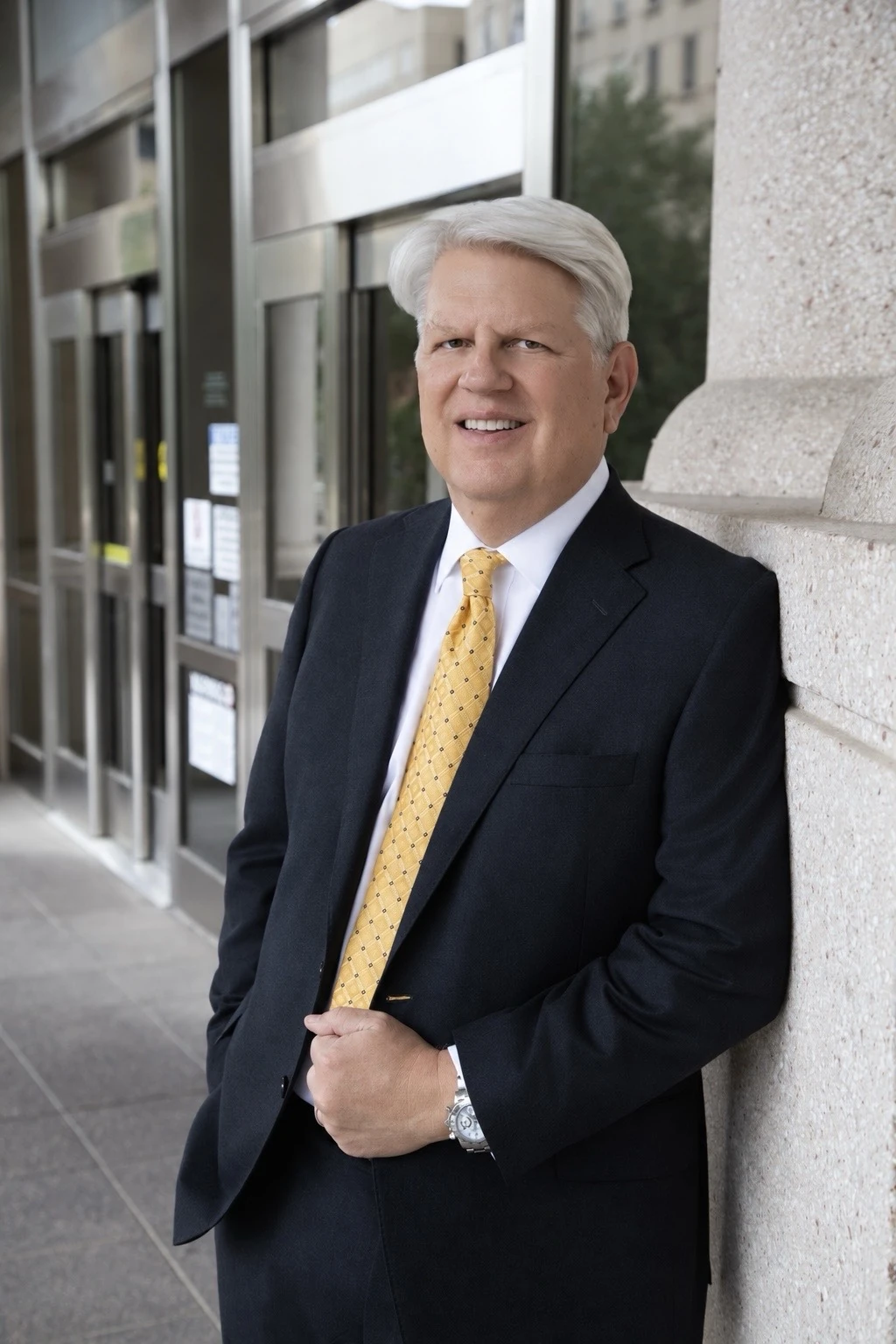 Byron K. Barclay standing beside a stone column